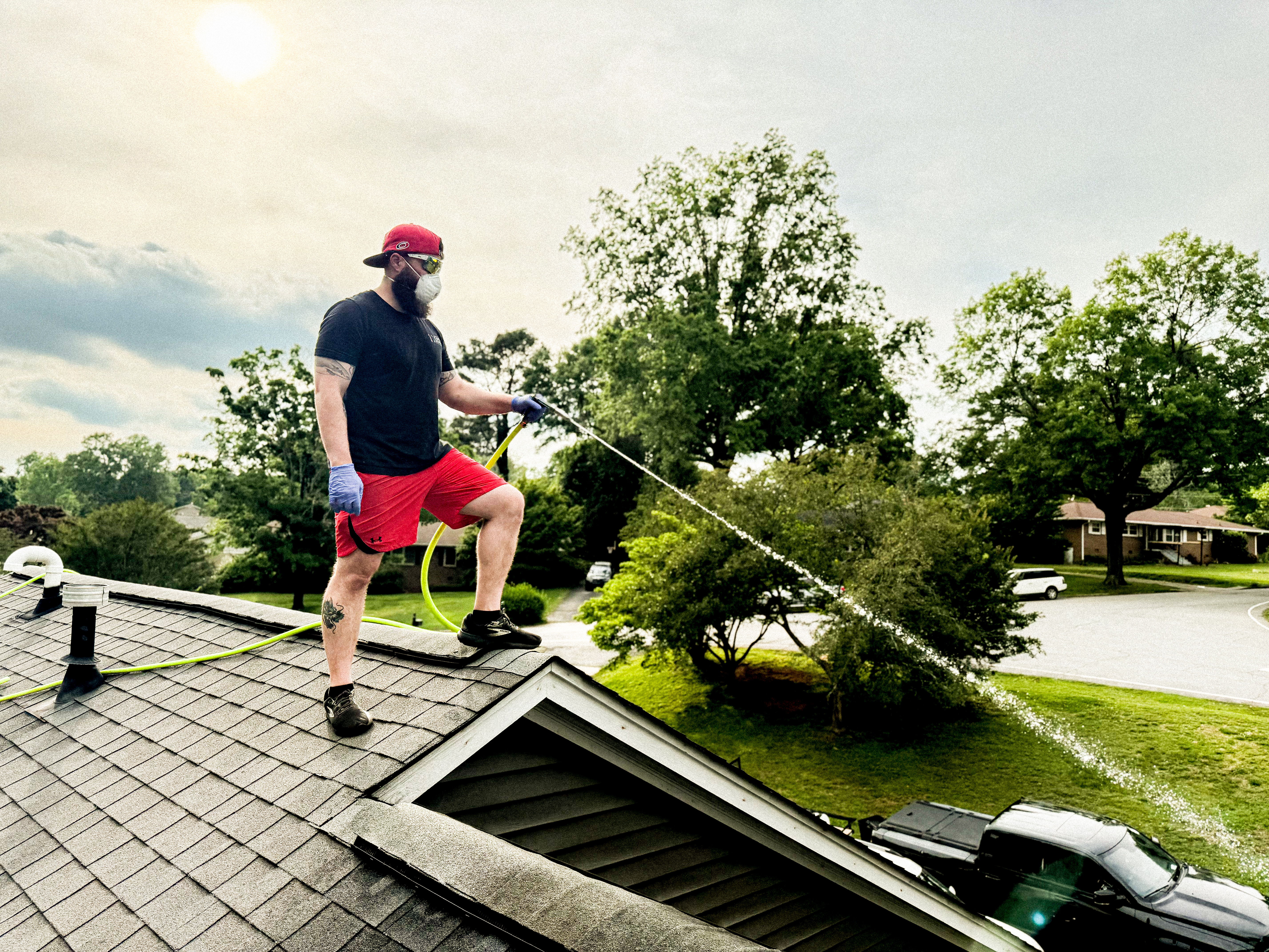 Moss Free technician soft washing a roof in Upstate SC